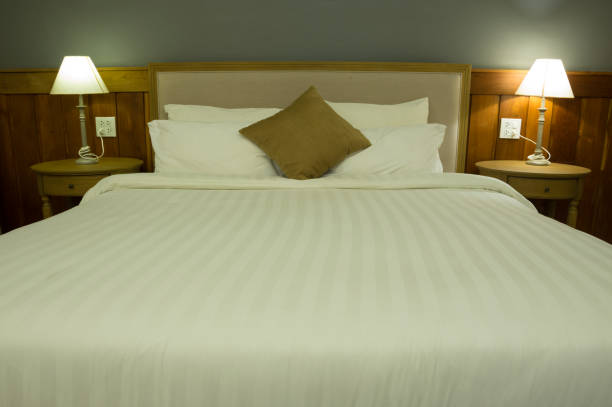 istock White bed and pillow in hotel room. 962256498