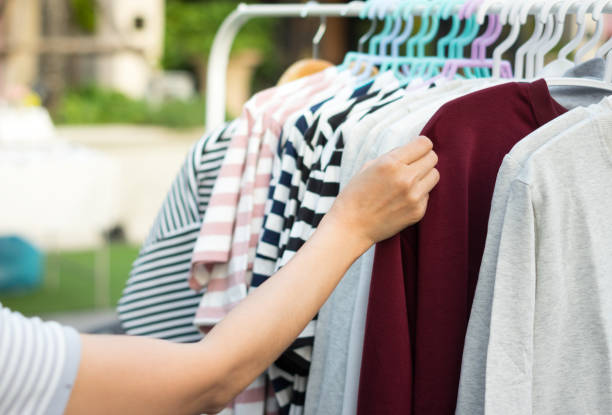 istock Female choosing shirt in shop 962256514