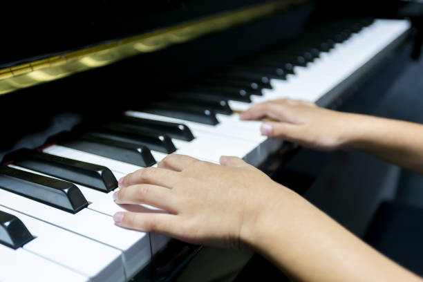 istock hands of kid playing piano 962257308