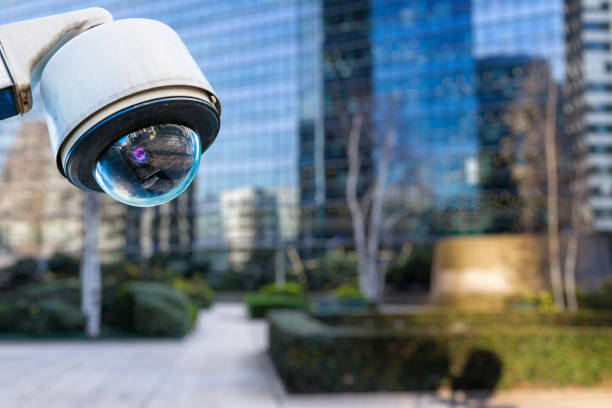 istock security CCTV camera or surveillance system with buildings on blurry background 962263120