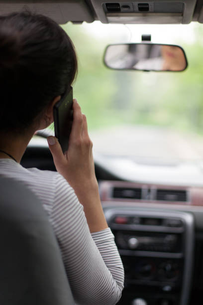 istock Rear View Of Woman Using Mobile Phone In Car 962264592