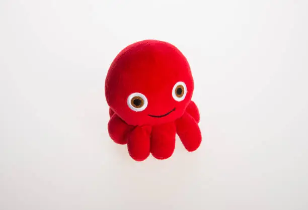 Photo of toy or octopus soft toy on the background