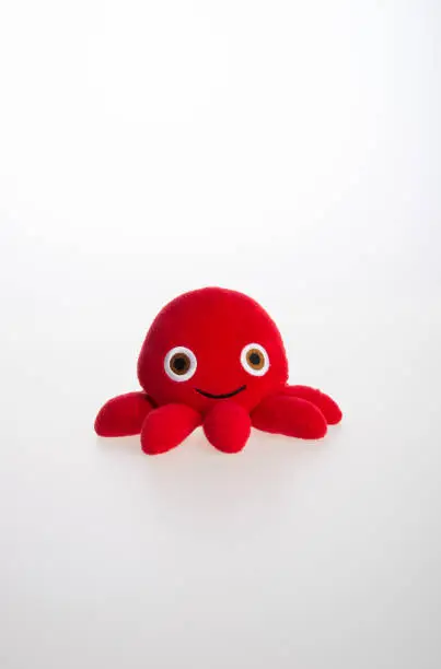 Photo of toy or octopus soft toy on the background