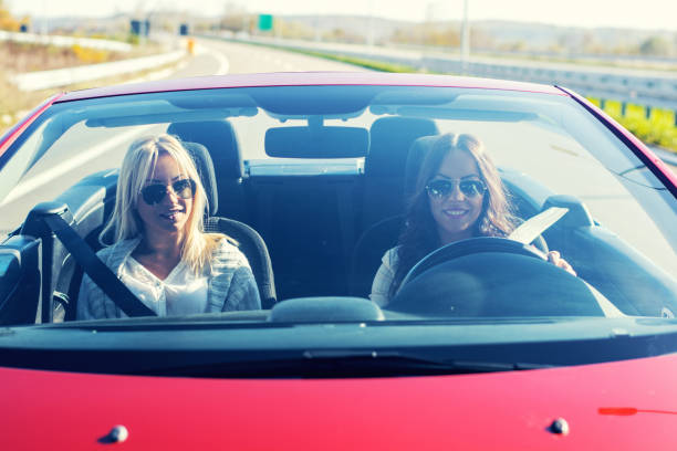 istock Smiling women enjoying in cabriolet 962268178