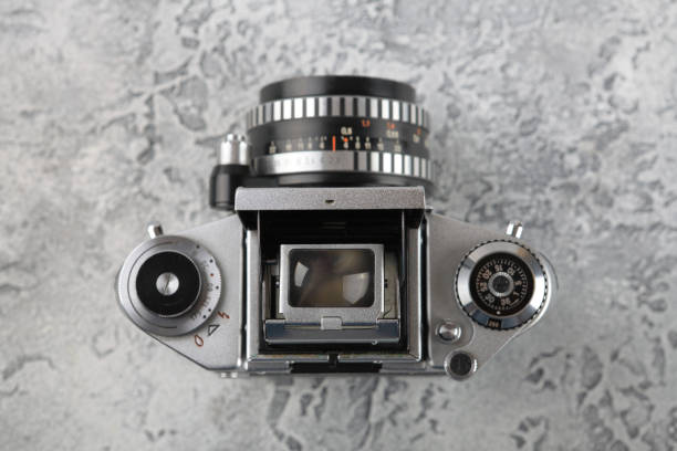 istock The old 35 mm SLR camera on a grey cement background. 962271376