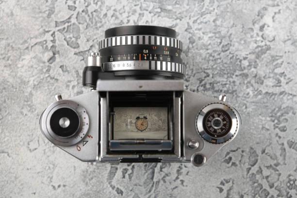 istock The old 35 mm film camera on a grey cement background. 962271406