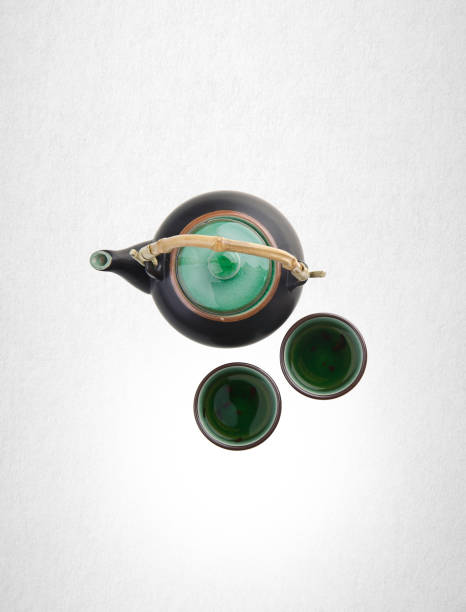 Chinese tea set with cups and tea pot on background.