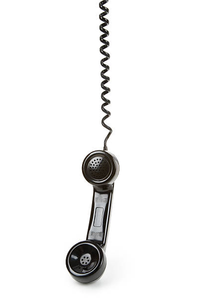 Black corded telephone on a plain white background stock photo