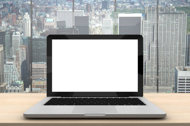 istock Laptop with blank screen on wood table in office 962279530