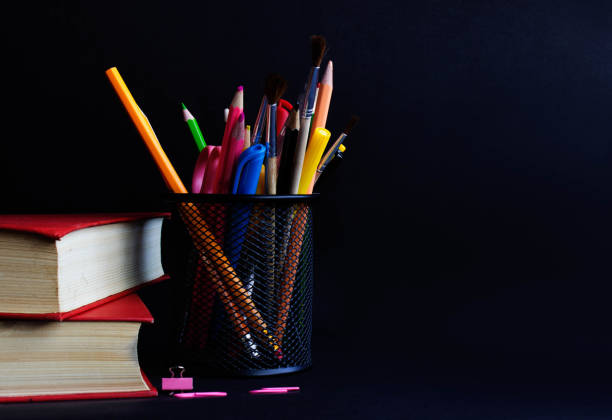 istock School supplies on blackboard or chalkboard black background. 962284412