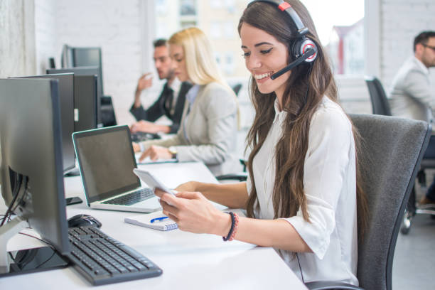 istock Beautiful business woman call operator with headset using mobile phone in office 962287110