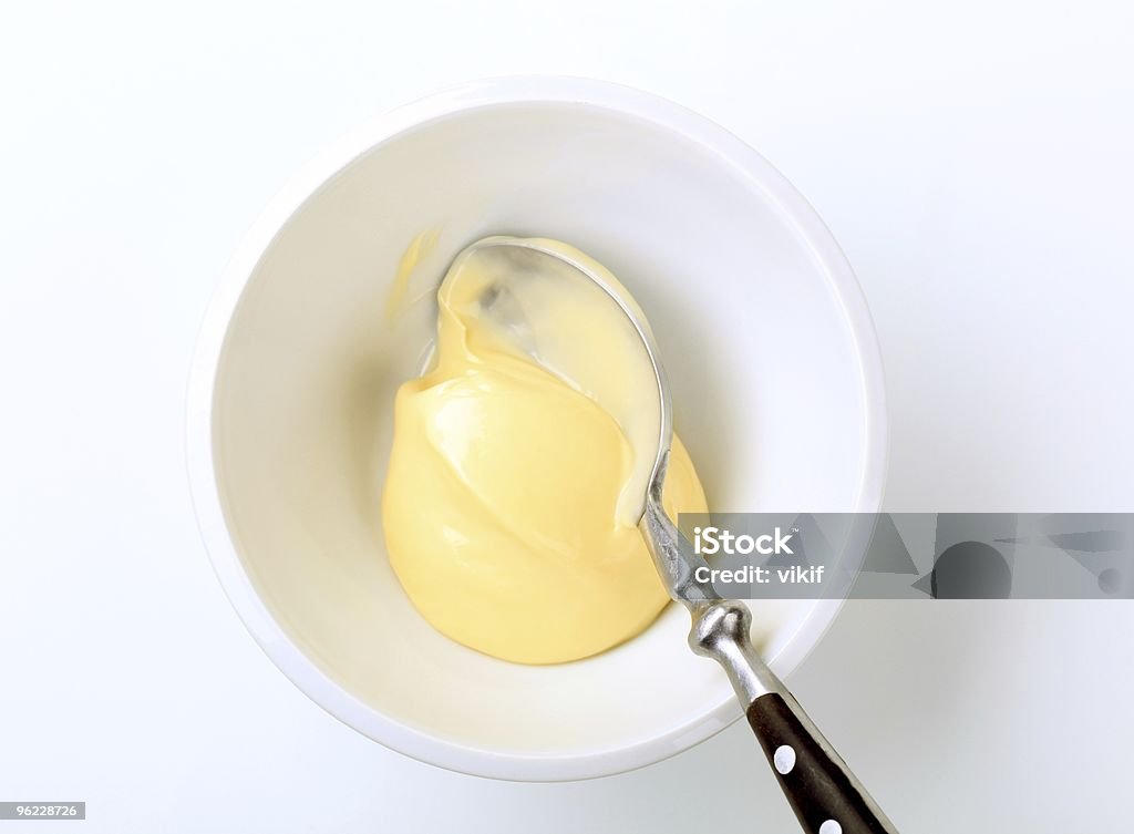 A bowl of mayonnaise with a spoon Bowl of homemade mayonnaise - overhead view Bowl Stock Photo