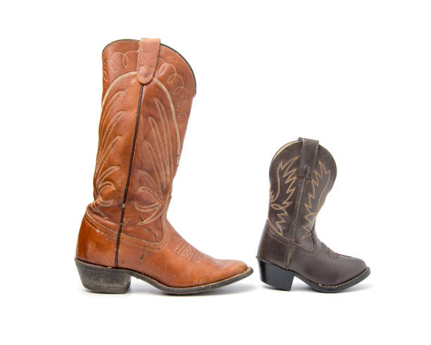 istock Brown cowboy boots isolated on a white background. 962294942