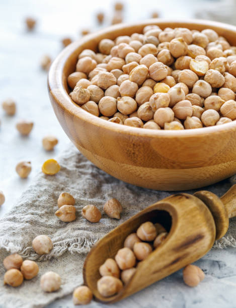 istock Organic chickpeas in bowl on white table. 962298686
