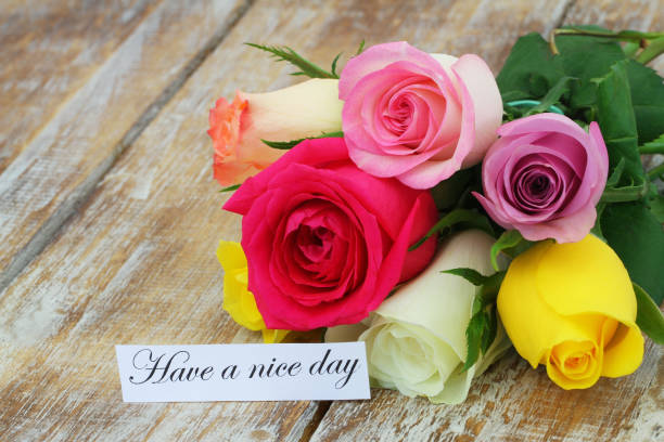 istock Have a nice day card with colorful rose bouquet on rustic wooden surface 962299650