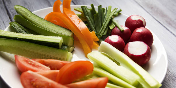 istock White plate with vegetables for a vegan salad 962301470