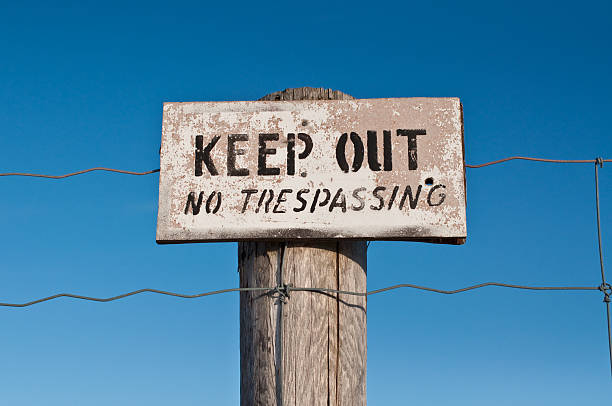 istock Keep Out Sign Nailed to a Fencepost with Blue Sky 96230202