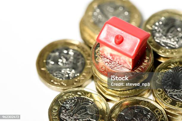 Macro Close Up Of A Miniature House Resting On New Pound Coins Stock Photo - Download Image Now