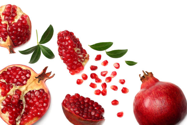 istock pomegranate fruit with green leaves isolated on a white background top view 962305512