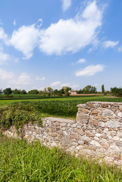 istock Countryside landscape with wall in the foreground and blue sky. 962310864