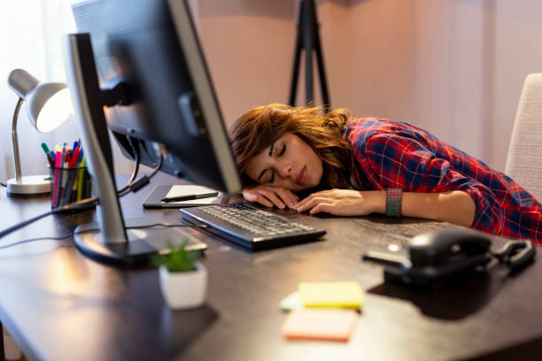 istock Tired woman asleep at her desk 962314228