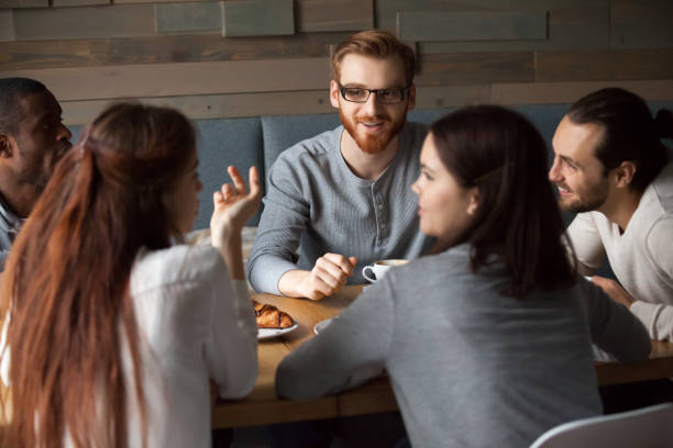 istock Diverse young people talking and having fun together in cafe 962315244