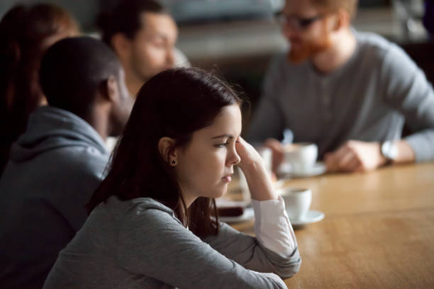 istock Frustrated upset millennial girl sitting alone at table in cafe 962315326