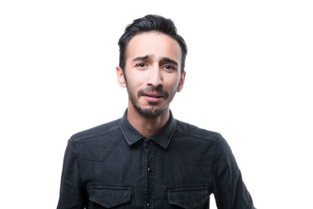 istock Portrait of sadness man looking at camera over white background 962316040