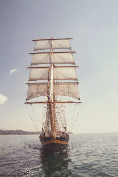istock old historical ship (yacht) with white sails, sailing in the sea 962316300