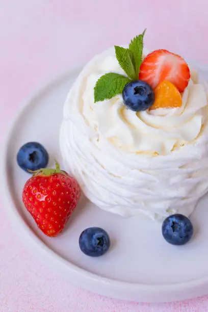 Meringue, Pavlova cake with strawberries, blueberries and mint, toned