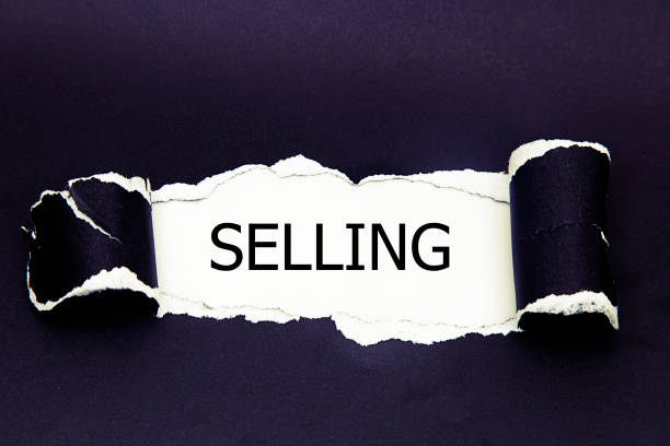 istock The word selling appearing behind torn paper 962322700