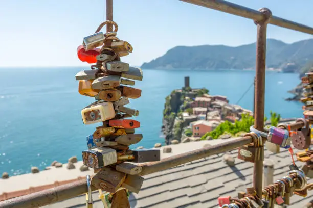 Lovelocks locked to a fence with sea view. Corniglia, 5 terre in Italy.