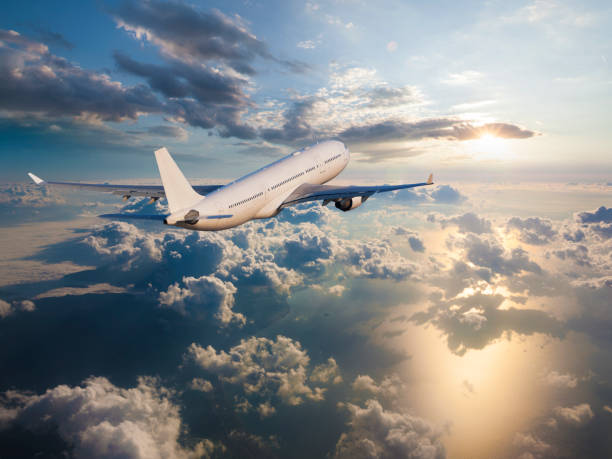 istock Passenger airplane flying above clouds at sunrise 962325896