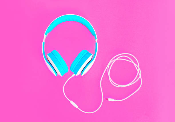 istock Cool headphones lie on colorful pink background 962326558