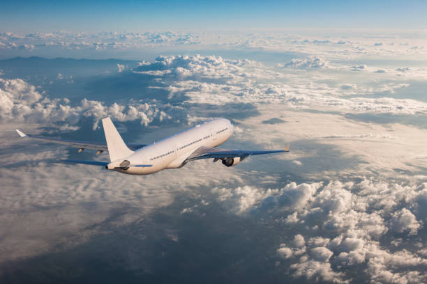 istock Passenger airplane flying above clouds 962326874