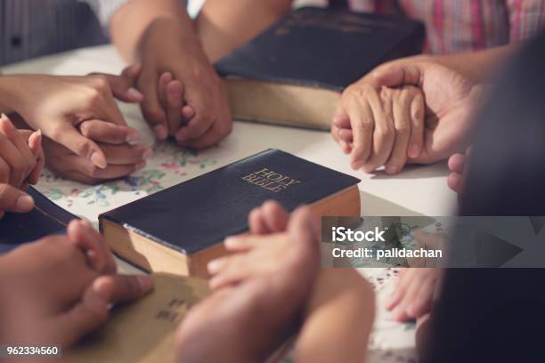 Christians And Bible Study Concept Group Of Discipleship Studying The Word Of God In Church And Christians Holding Each Others Hand Praying Together Stock Photo - Download Image Now