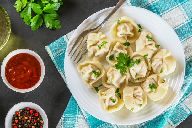 istock Homemade ready dumplings on a gray concrete table. 962334880