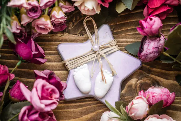 Scented stone as a gift for baby shower on wooden background