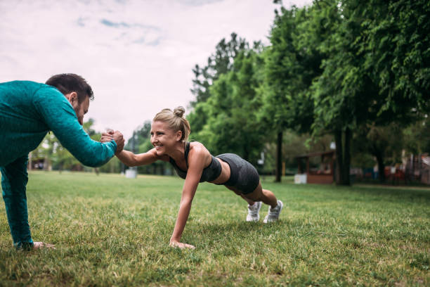 istock Two fit young people clapping hands from plank position during partner workout. 962341026