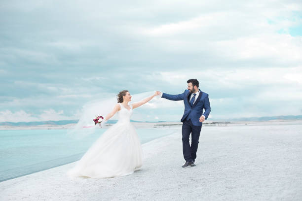 Bride and Groom are dancing on the beach