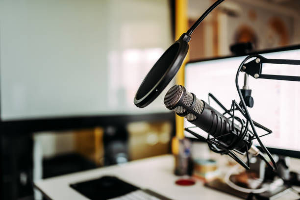 Close-up image of microphone in podcast studio. Close-up image of microphone in podcast studio. podcasting photos stock pictures, royalty-free photos & images