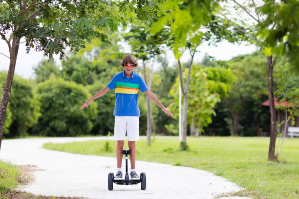 istock Child on hover board. Kids riding scooter 962348082