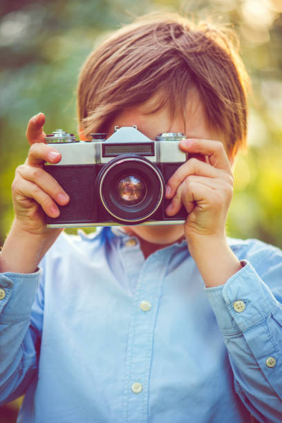 istock Little boy photographing in park 962348622