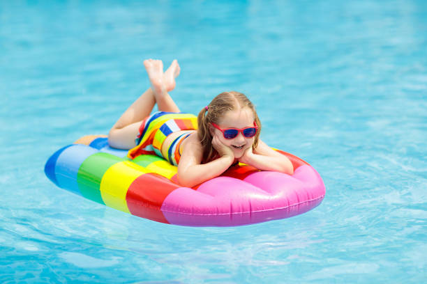 istock Child on inflatable float in swimming pool. 962348770