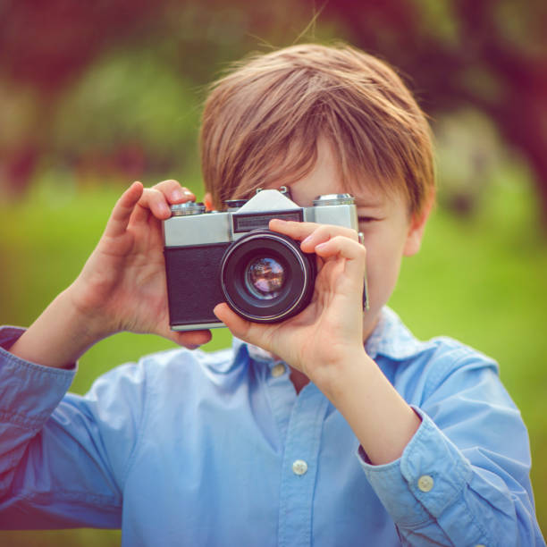 istock Little boy photographing in park 962350842