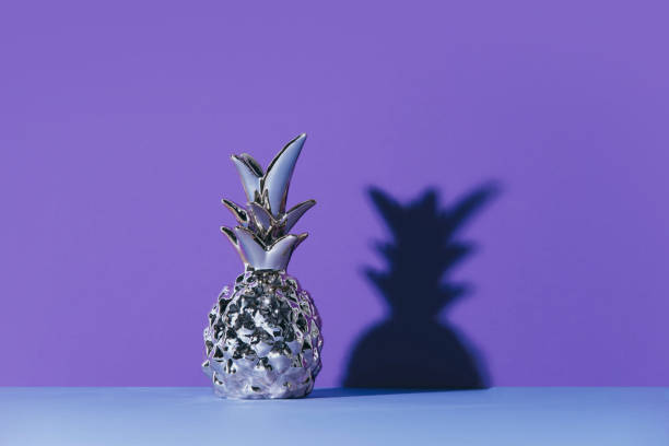 istock Tropical golden Pineapple on ultraviolet background 962351984