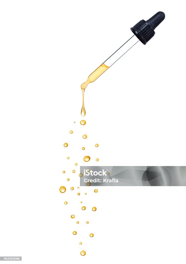 Close-up of dropper with falling drops isolated on white background Dropper Stock Photo