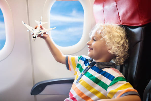 istock Child flying in airplane. Flight with kids. 962352142
