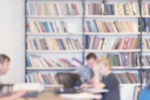 Abstract unrecognizable studenten in public library, in reading room. Blurred bookshelves of bookcase with books, studing, education. Light filter effect, soft focus Abstract unrecognizable friends, studenten in public library, in reading room. Blurred bookshelves of bookcase with books. Light filter effect, soft focus. Concept of culture, learning, studing, education studenten stock pictures, royalty-free photos & images