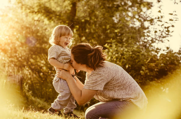 istock Mother With Son Playing Outdoors 962374616
